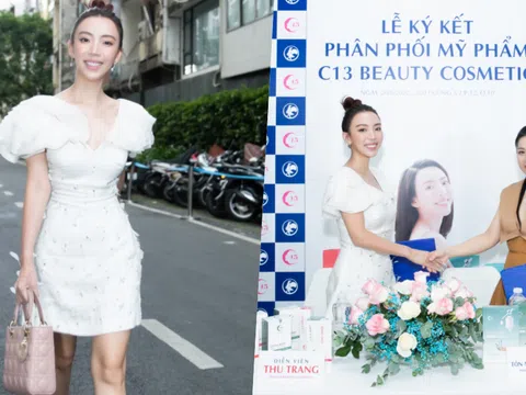 Thu Trang diện váy trắng, xách túi hiệu Dior đi ký kết sản phẩm